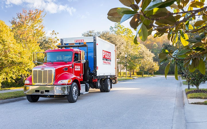 A truck delivering a PODS container in small-town Alabama