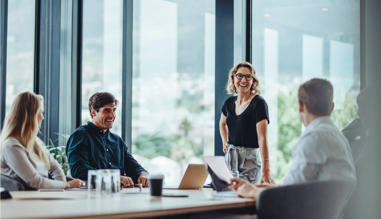 A group of professionals are smiling during a business meeting in a corporate building in Chicago, Illinois.