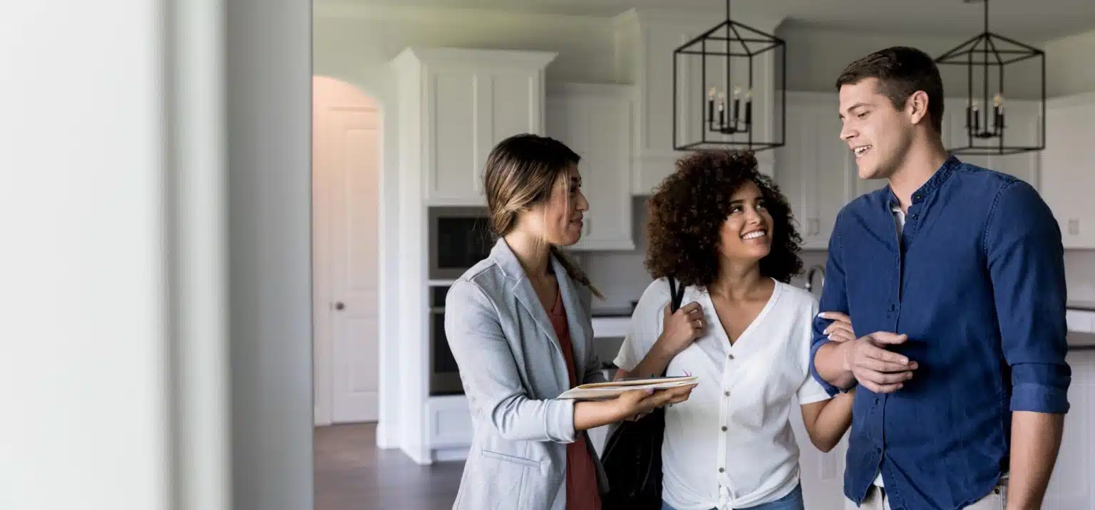couple with realtor inside home for sale