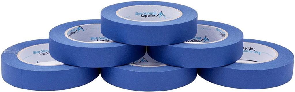 Six rolls of blue painter's tape neatly stacked in a pyramid