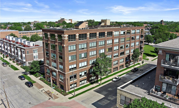 Aerial view of a large, brick building with loft apartments in the Brewer’s Hill neighborhood of Milwaukee, Wisconsin. 