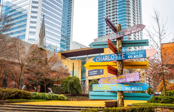 Colorful stacked signs in Charlotte, North Carolina, mark the distance and point the way to other U.S. cities.