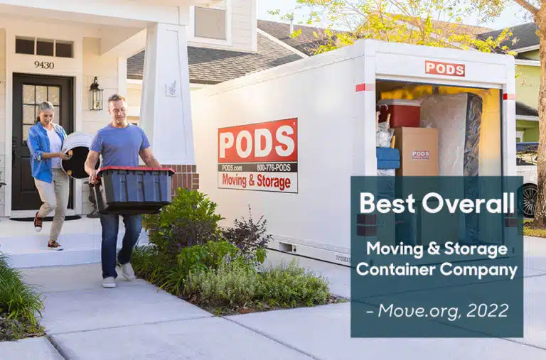 couple carrying things to load into their PODS container