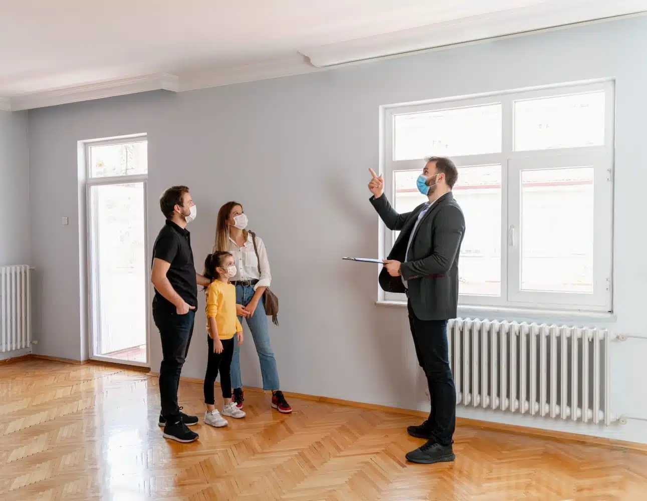 homebuyers and real estate agent wearing face coverings