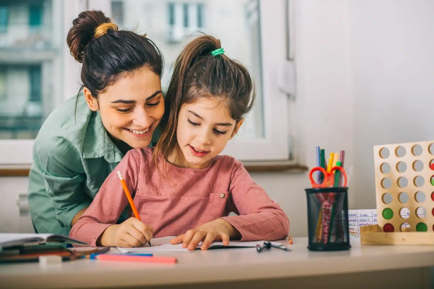 mom helping kid homeschool