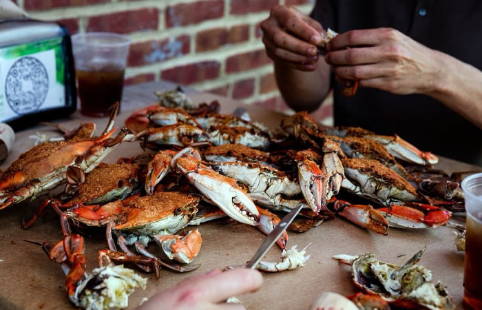 Close-up of a crab feast on a paper-covered table at a restaurant in Baltimore, Maryland.
