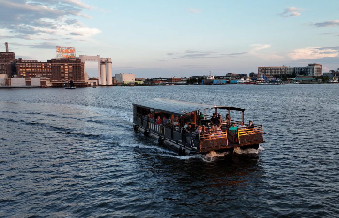 The Baltimore Water Taxi transports people across the harbor just before sunset.
