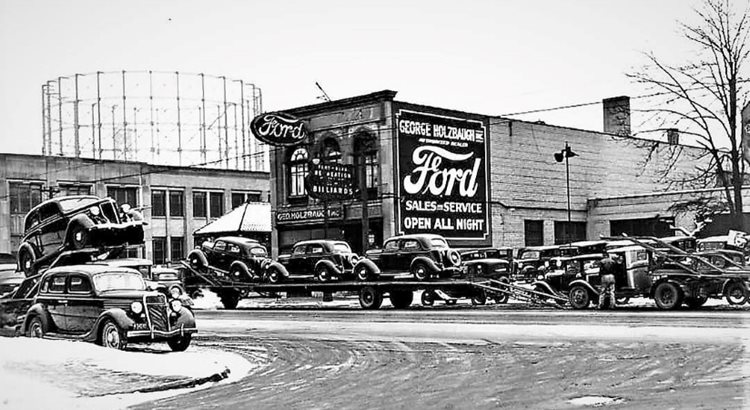 A black-and-white photograph of a Detroit Ford dealership in 1936