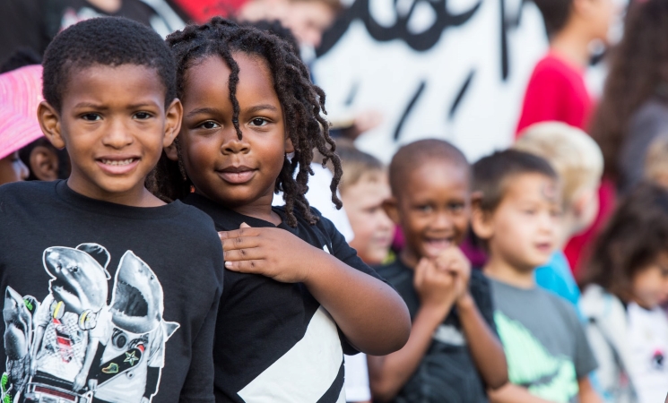 Two young kids pose for a picture during an assembly at their school in Detroit.