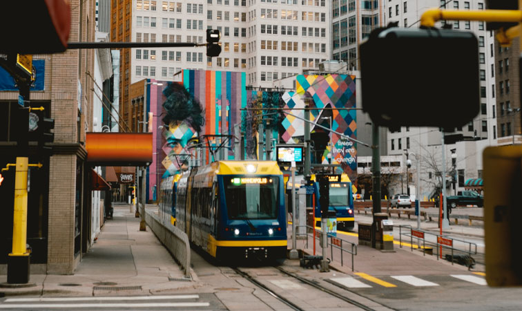 City trams are moving past mural walls in Downtown West, one of the best Minneapolis neighborhoods