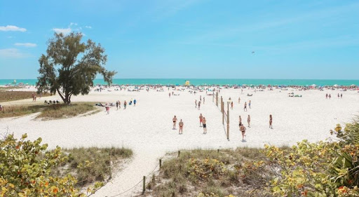 Locals and tourists alike enjoy a warm, sunny day at Siesta Key Beach in Sarasota County.