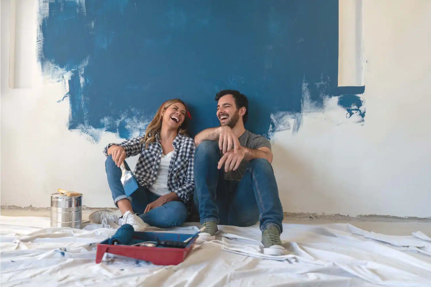 happy couple painting home