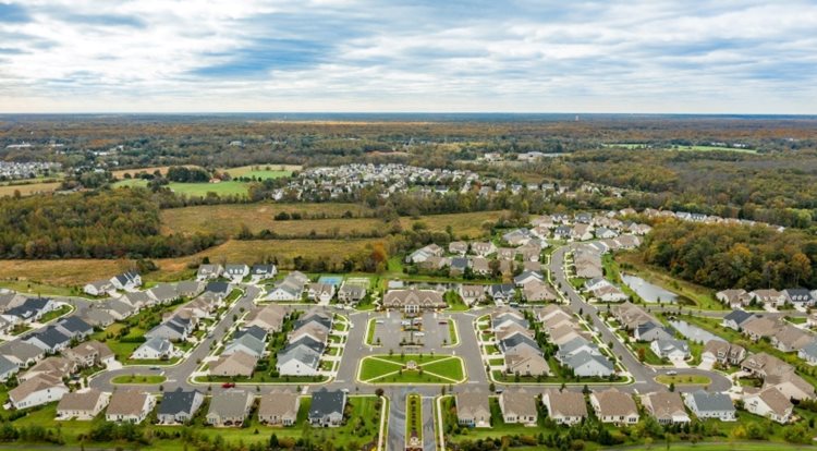 Aerial view of a sprawling new-construction neighborhood in Medford, New Jersey. The houses are large and neatly arranged in rows. 
