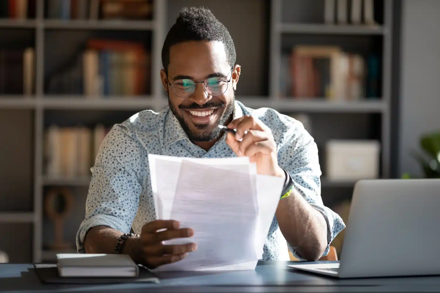 man looking over paperwork contract agreement