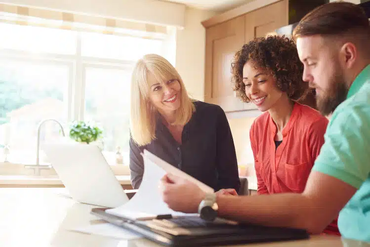 realtor looking over offer with couple