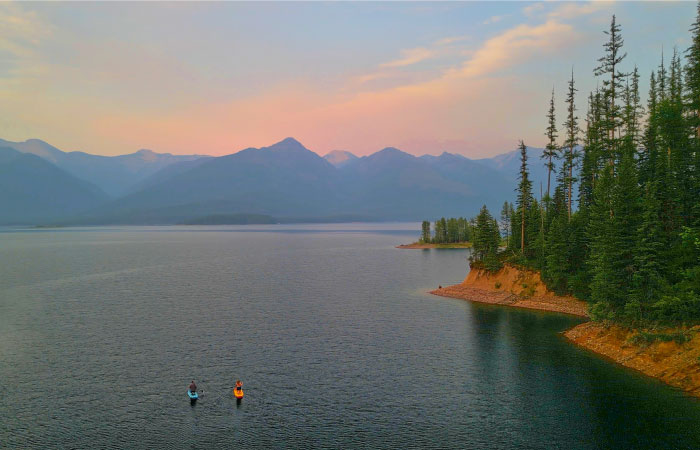 A couple of kayakers explore the breathtaking views in Montana’s Hungry Horse Reservoir.