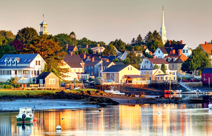 The late afternoon light is reflecting off coastal homes in Portsmouth, New Hampshire, as the tide goes out.