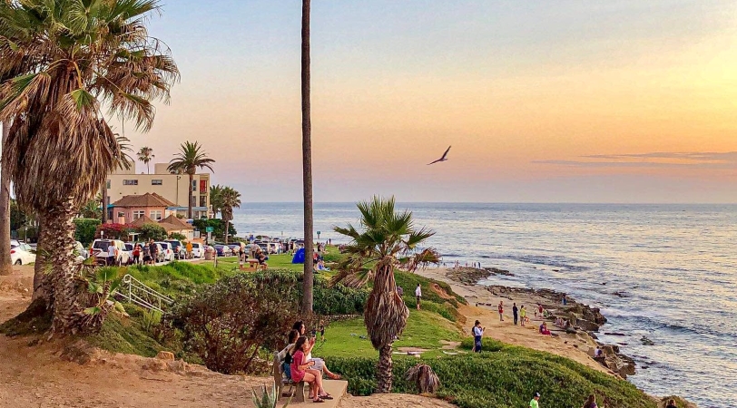 Locals are enjoying the sunset at a beach in La Jolla, considered one of the best areas of San Diego. 