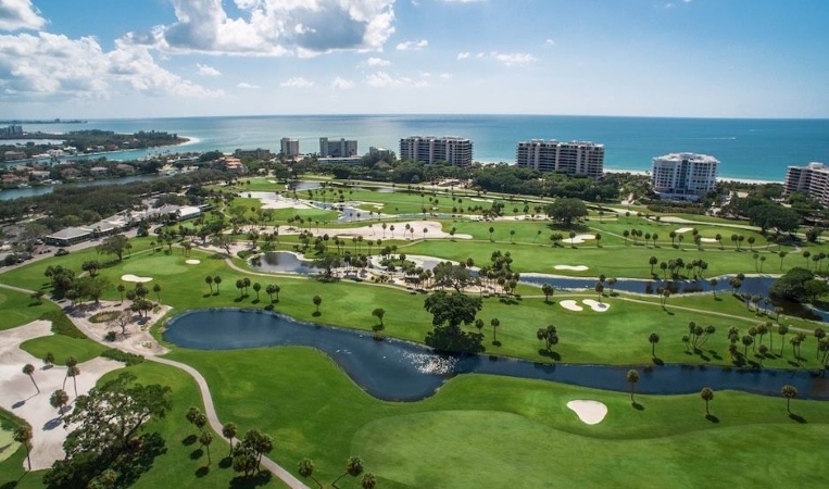 The pristine golf course at The Resort at Longboat Key Club, with the Gulf of Mexico in the distance.