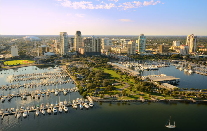 An aerial shot of a busy marina in St. Petersburg, with the rest of the city in the background.