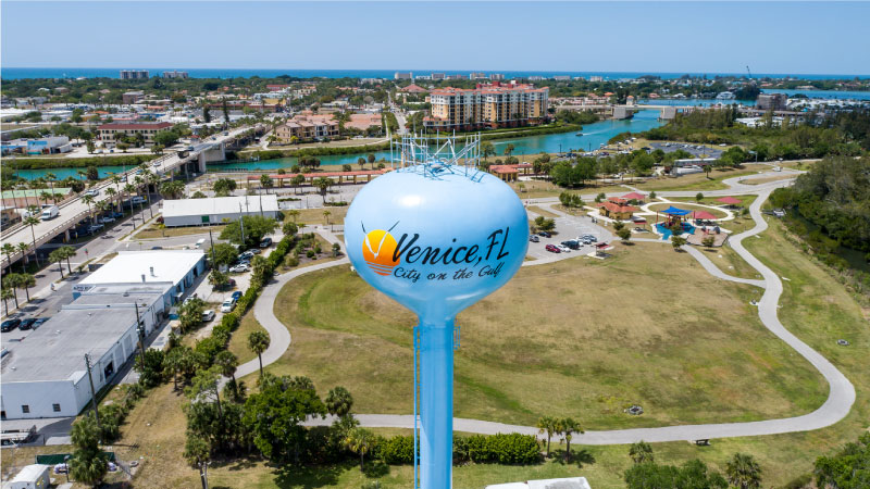 An aerial close-up shot of the Venice, Florida, water tower with the city as the backdrop.