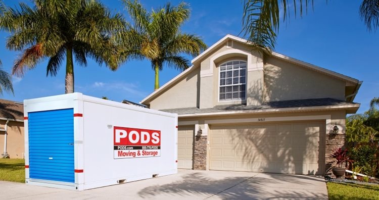 A PODS moving and storage container is conveniently positioned in the residential driveway of a Florida home.