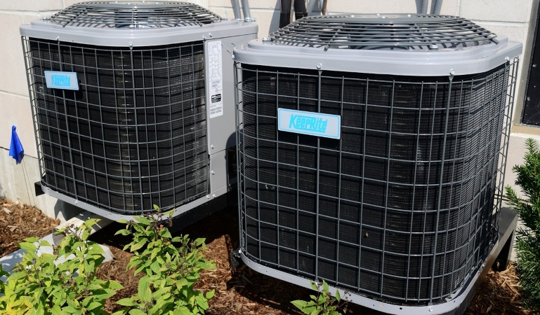 A set of air conditioning units outside a residential property in Florida.