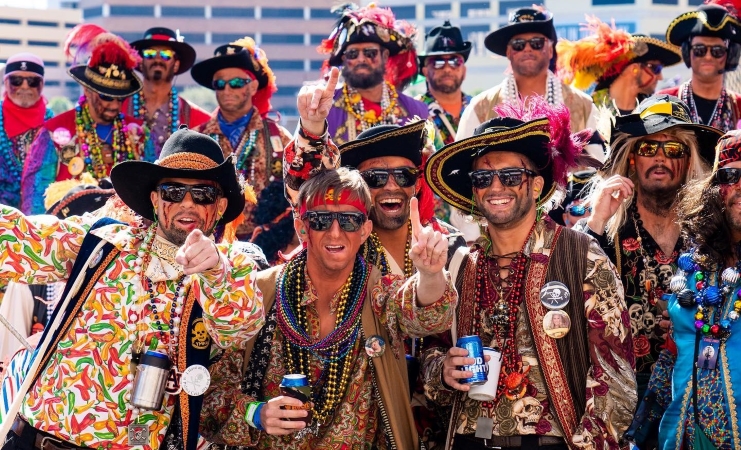 A group of people are dressed in ornate pirate costumes as they partake in the Gasparilla Pirate Fest in Tampa, Florida. 