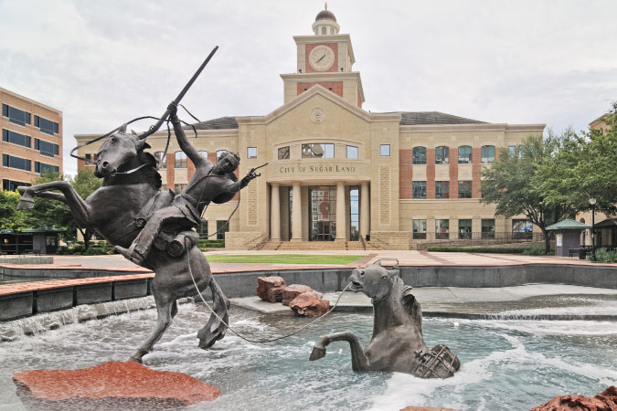The water fountain in front of City Hall in Sugar Land, Texas, features an impressive sculpture depicting Stephen F. Austin on horseback, emerging from the Brazos River with a packhorse in tow.