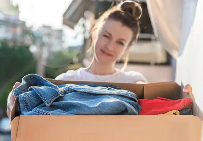 woman with box of clothing donations
