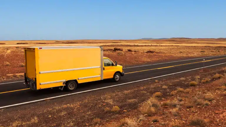 yellow moving truck on freeway