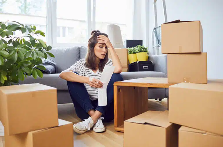 A  woman looks stressed as she reviews her moving bill