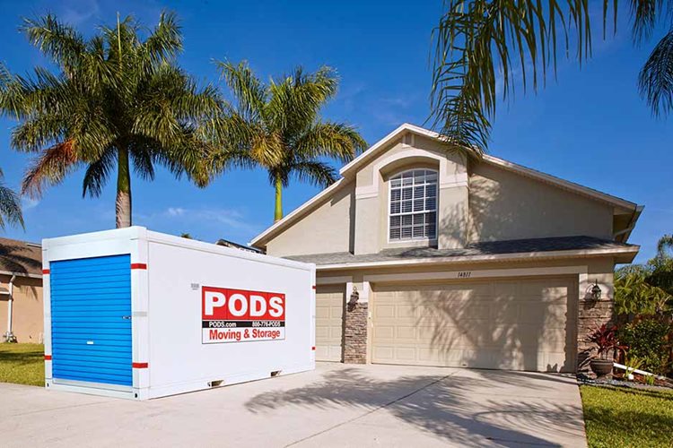 A PODS moving and storage container in front of a house