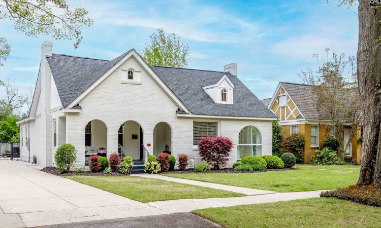 A beautiful single-family home in Columbia’s Shandon neighborhood. The home is made of white brick and features a covered multi-arch entryway. 