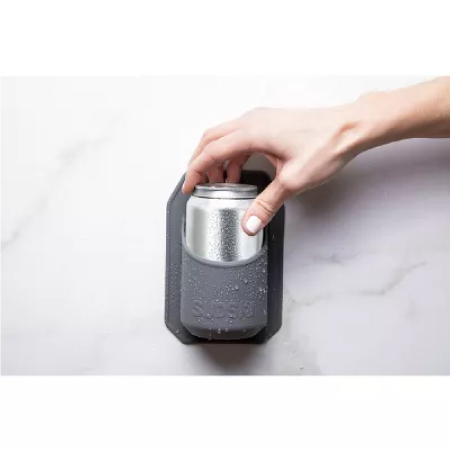 Image of a hand placing a cold beer in a silicone shower beer holder that is mounted on the shower wall