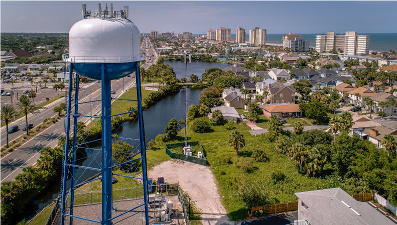 Aerial view of the Jacksonville Beach neighborhood with the water tower in the foreground and beach high rises in the background.