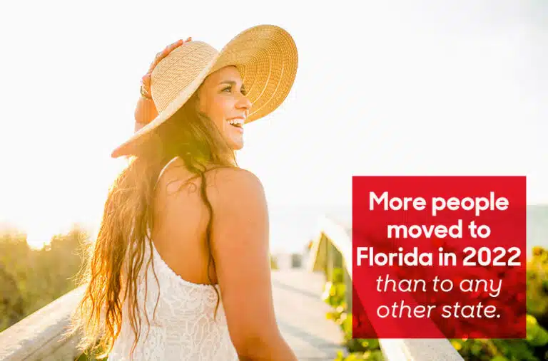 A woman in a sun hat walking onto a beach. Overlaid text reads "More people moved to Florida in 2022 than any other state"
