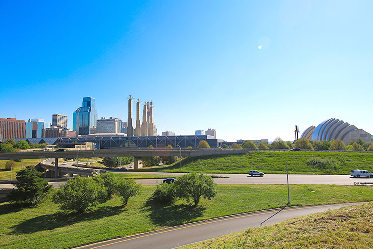 The Crossroads Art District seen from a nearby highway. The contemporary Kauffman Center, home to the Kansas City Symphony and Ballet, stands to the right-hand side. 