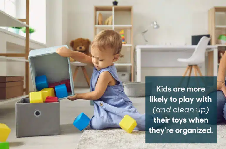 toddler pouring out toys of a toy box