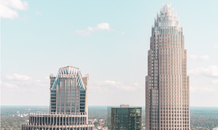 A rooftop view of two skyscrapers in Charlotte, NC, including the Bank of America Tower. Is Charlotte, NC, a good place to live? It is if you’re looking to work in the finance industry.