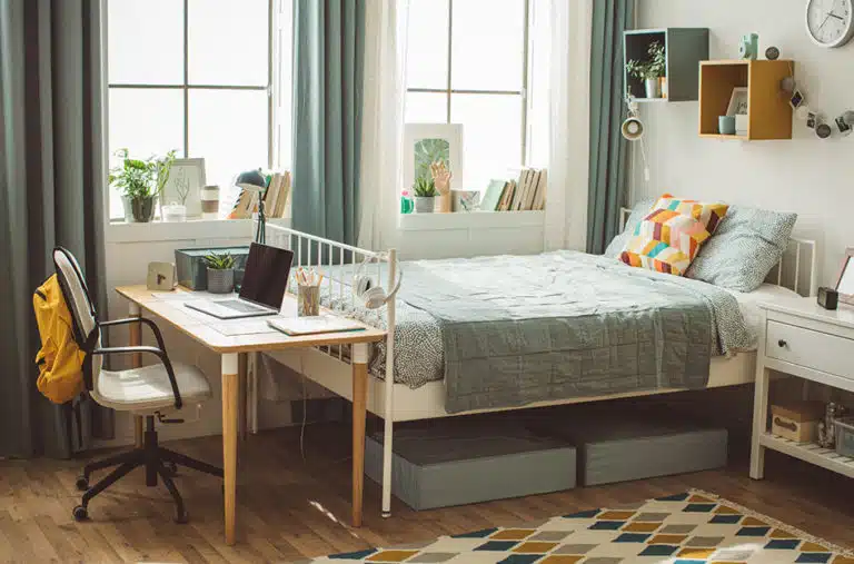 organized and decorated dorm room with storage