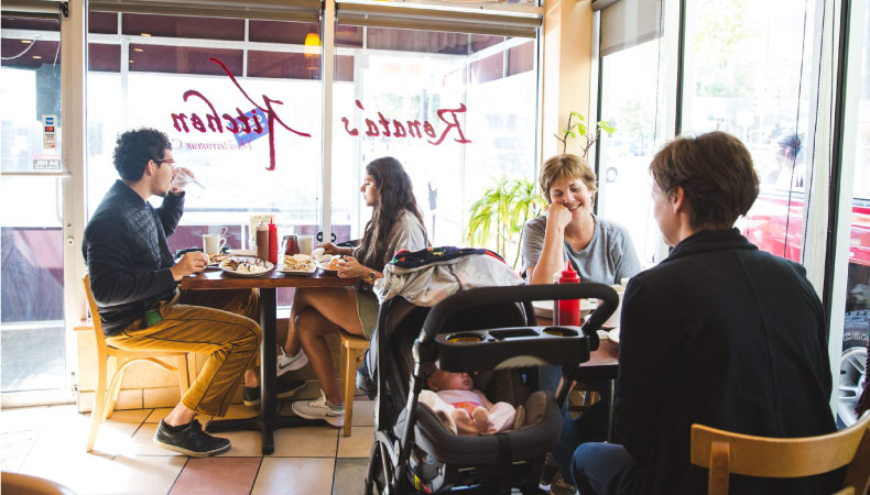 Locals dine at a sunny restaurant in the University City neighborhood of Philadelphia.