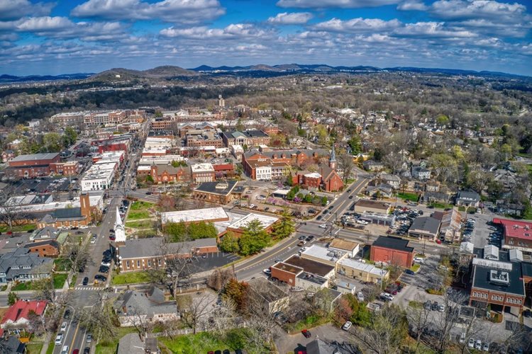 A springtime aerial view of Franklin, Tennessee, with the Great Smoky Mountains visible in the distance.