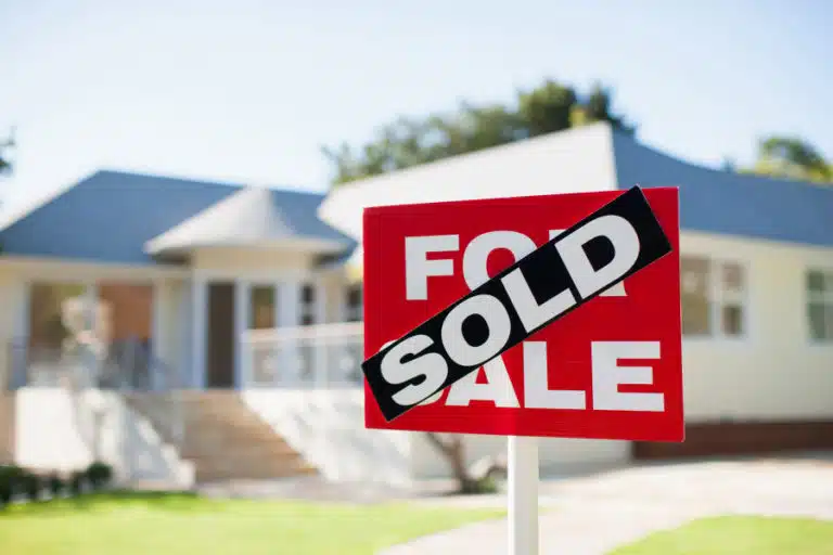 for sale sign with sold sticker