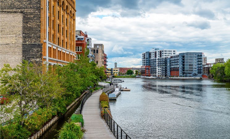 A riverside view of Milwaukee, Wisconsin, from the Riverwalk in the city’s Historic Third Ward neighborhood.