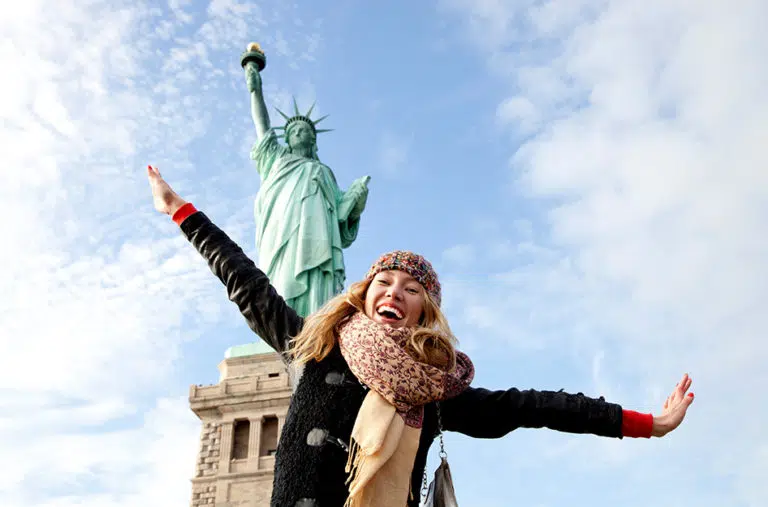 A girl posing from the base of the Statue of Liberty