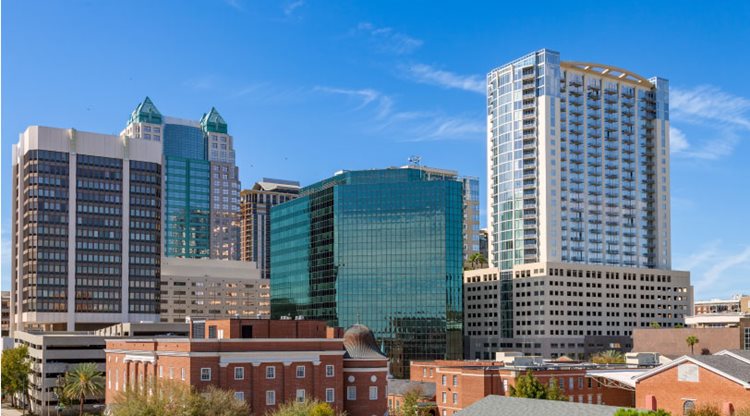 Tall city buildings are shining in the midday sun in the Central Business District, one of the best neighborhoods in Orlando