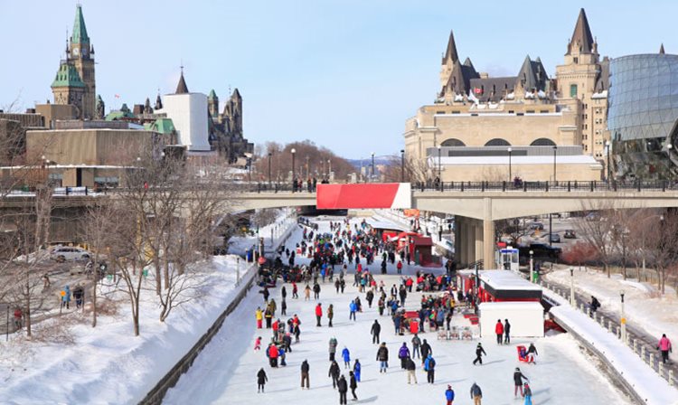 People ice skating at the Rideau Canal Ice Skating Rink in Ottawa, Ontario.