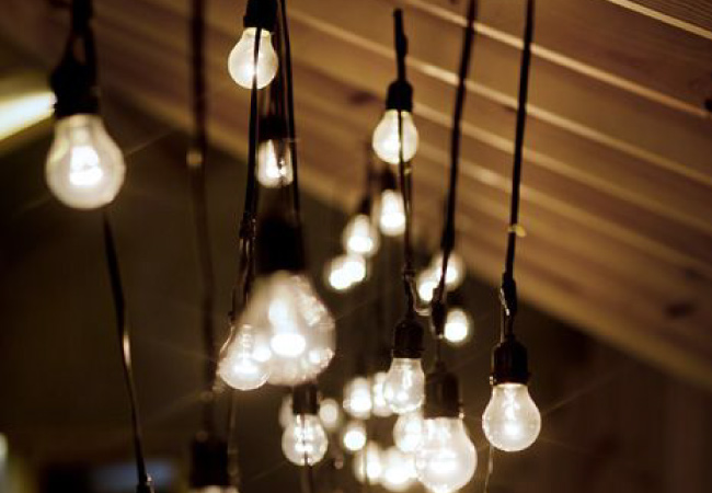 String lights hung up along the rafters of an attic. 
