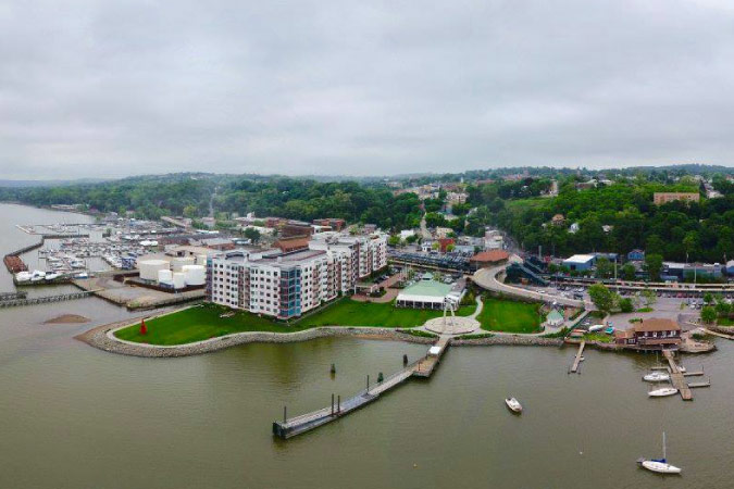 Aerial view of the riverfront in the village of Ossining, New York, on a cloudy day. 
